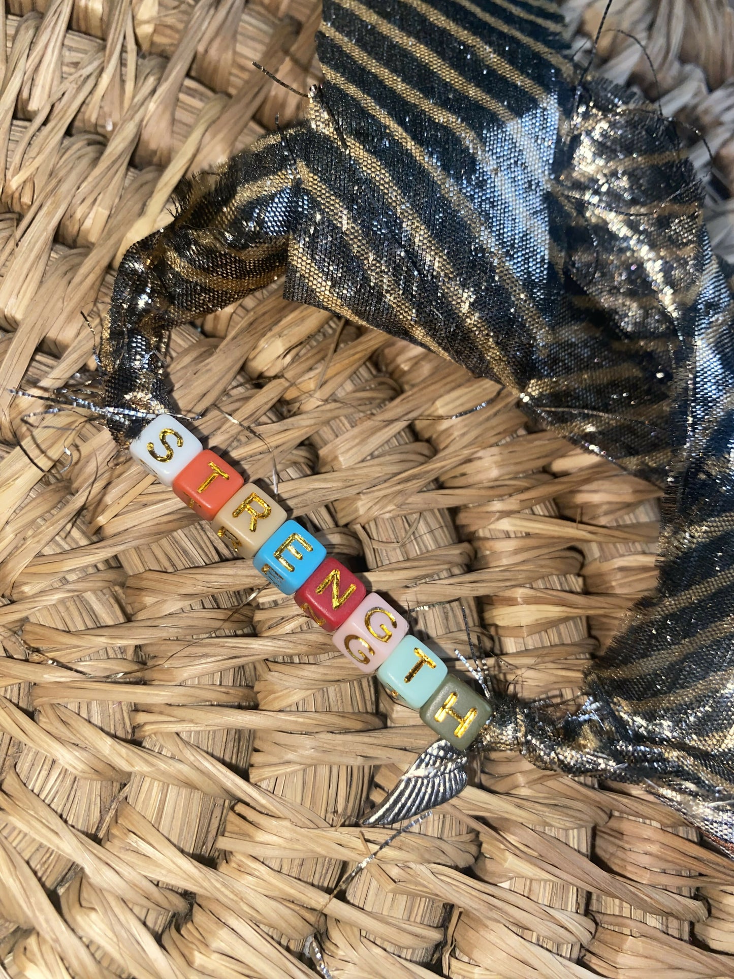 Strength with Wing Charm (Adult)