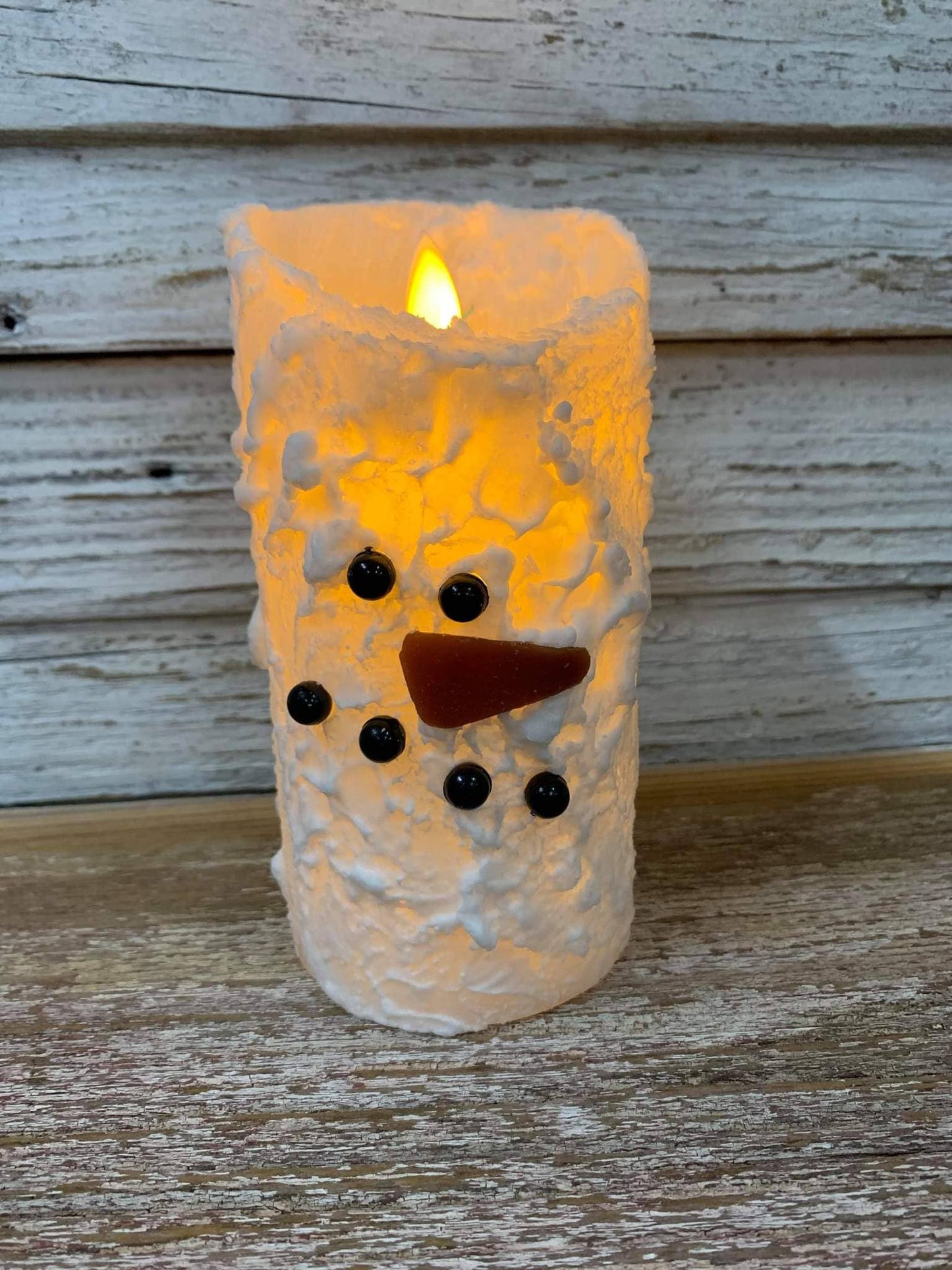 Snowman moving flame candle